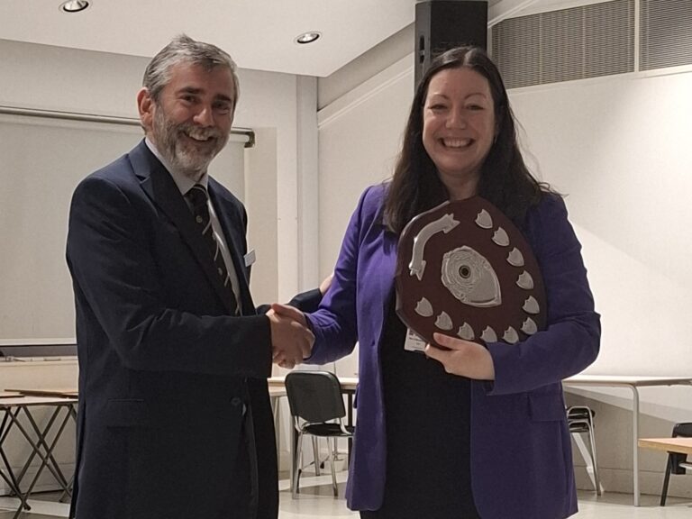 Province 18 Director Kevin Rourke presents shield to the winning school, St Gregory's